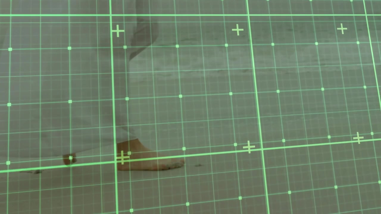 Bare feet walking under white flowing dress on wet sand with green grid scanning overlay animation