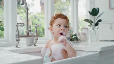 happy baby bathing funny toddler taking bath in kitchen sink having fun with soap bubbles 4k