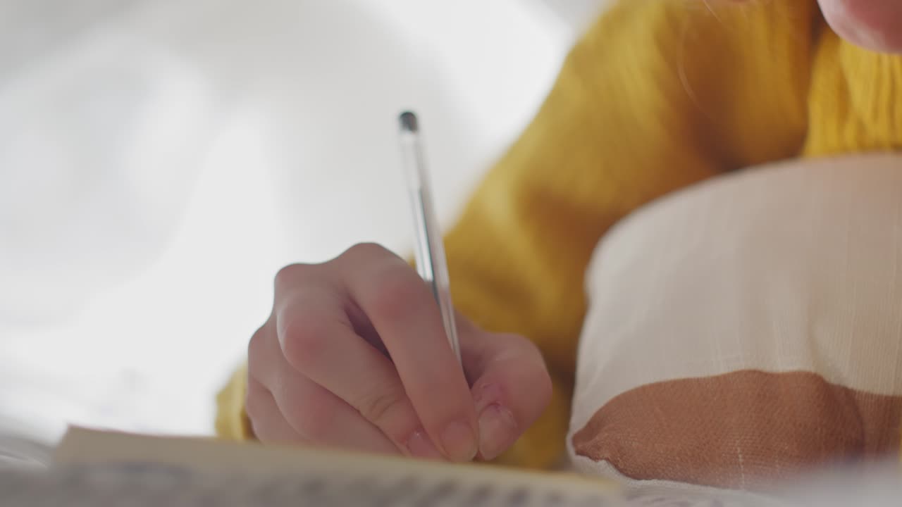Woman writing journaling in diary