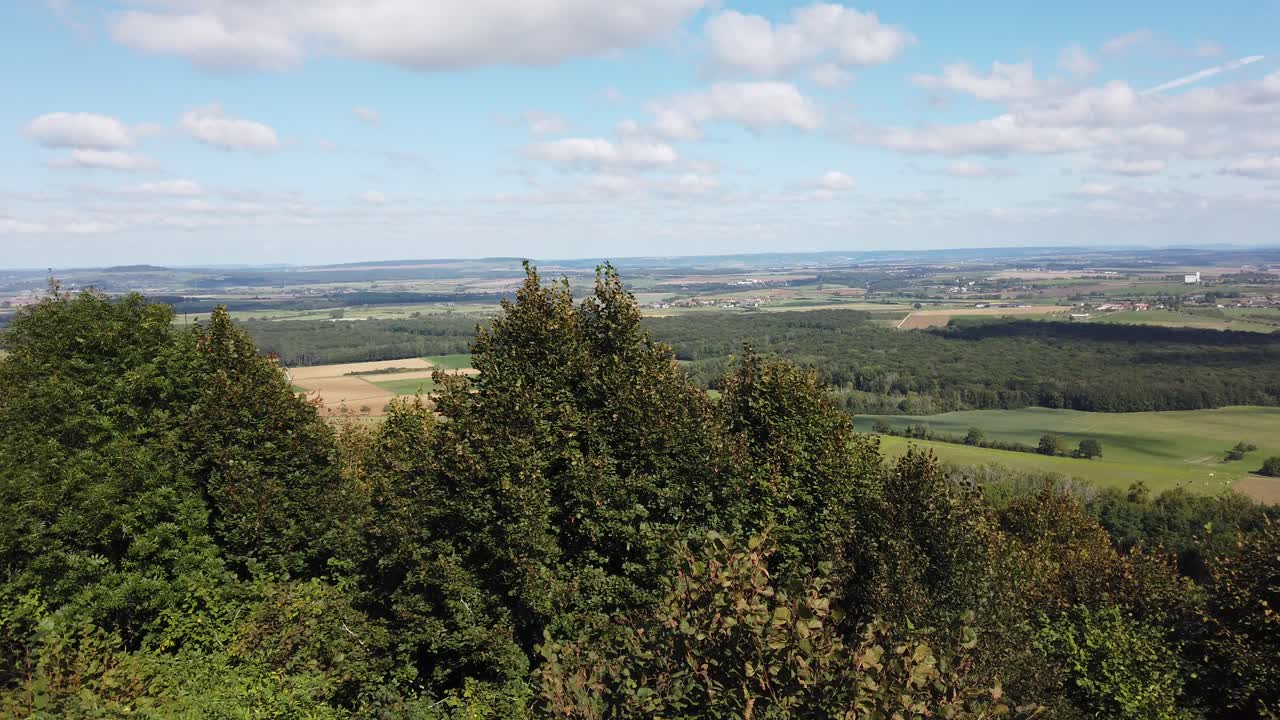 Breathtaking panoramic view from Colline de Sion Vaudémont, showcasing lush greenery, rolling hills, and distant landscapes under a clear sky.