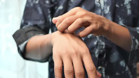 person scratching their arm