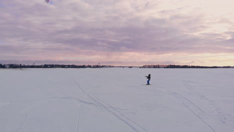 Kite-surfing-on-a-frozen-lake-in-winter-at-sunset