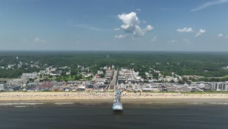 wide drone shot approaching the old orchard beach off maine's coast