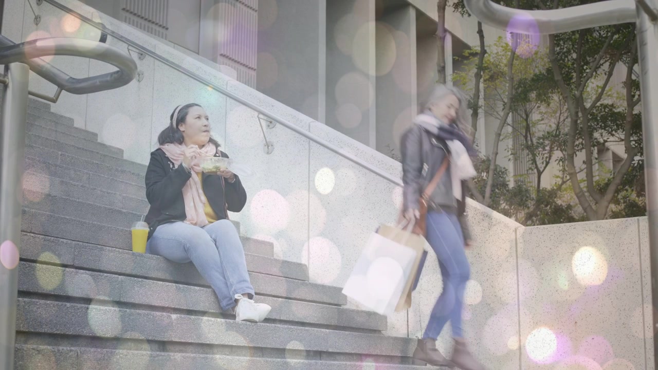 Senior woman sitting steps eating takeout, watching passerby descend checking safety, bokeh overlay
