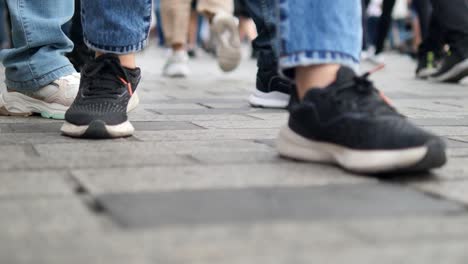 people walking on a cobblestone street