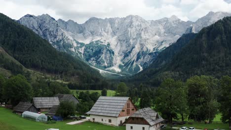 aerial view of alpine valley with rustic farm in front, jezersko, slovenia, european alps, scenic mountain landscape