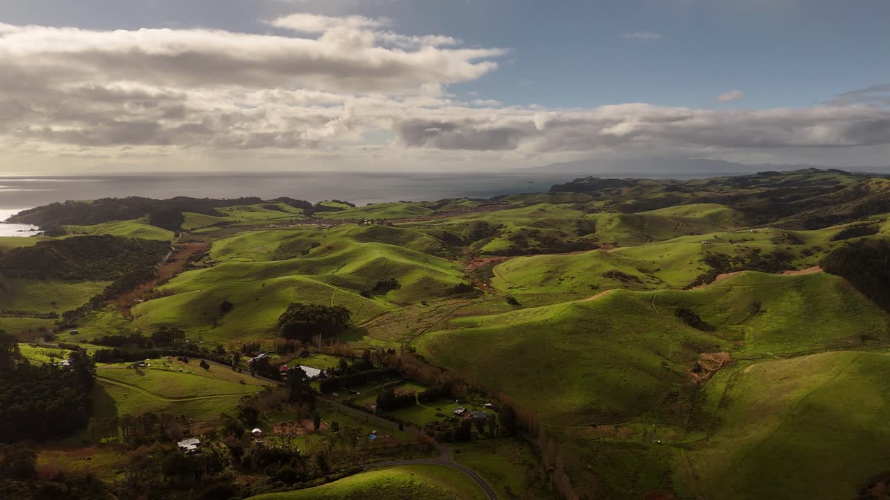 Aerial view of Stony Batter Historic Reserve on East Waiheke Island, New Zealand showing rolling green hills, rocky terrain, and coastal landscapes