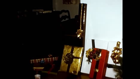 wooden table with boxes and presents. circa usa - 1970s: a 1970s video archive from the usa showcasing a wooden table adorned with various boxes and presents.