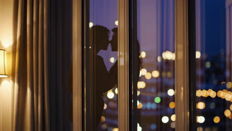 romantic couple silhouettes against night city lights