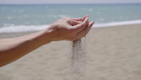 stream of sand pouring from hands