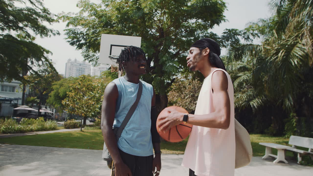 Black Men Chatting on Streetball Playground