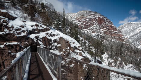 time lapse, footbridge on hiking trail on snow capped hills above ouray colorado usa