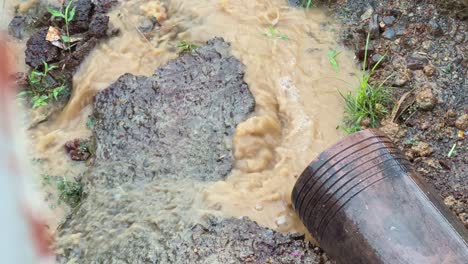 water gushing from a drainage pipe or gutter line during the rainfall