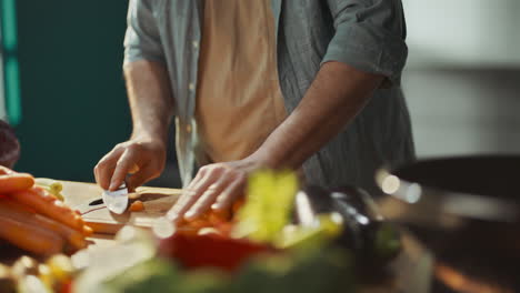 man chopping vegetables in a kitchen