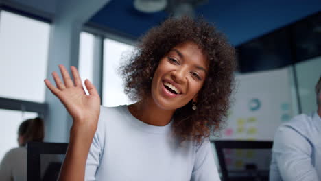 Businesswoman-talking-with-coworker-in-online-chat.-Professional-waving-hand