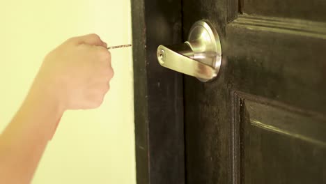 a person locks a door using a key, focusing on the handle and lock mechanism