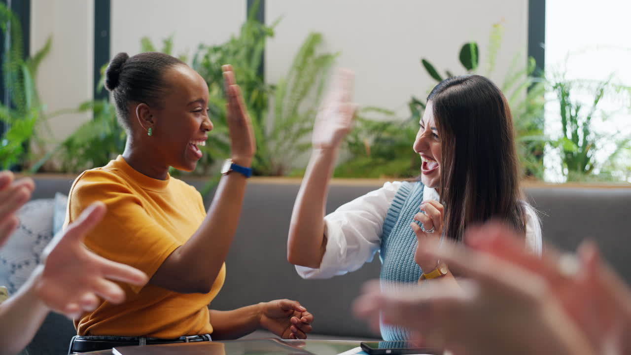 Diverse Business Team High-Fiving and Clapping in Office Meeting