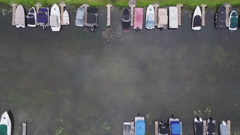 top view of boats parked on the pier at the marina - drone shot