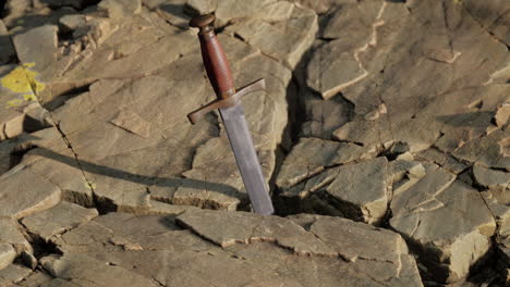 excalibur sword in rocky stone at sunset