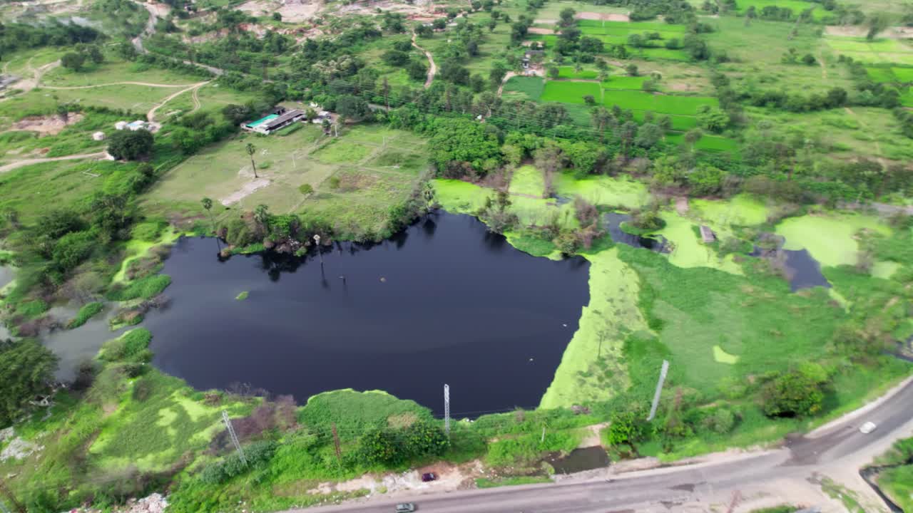 Crop field lands with water pond and current poles. day time, jib shot, drone shot, 4k