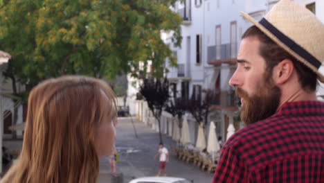 couple on talk as they walk through ibiza town, back view, shot on r3d