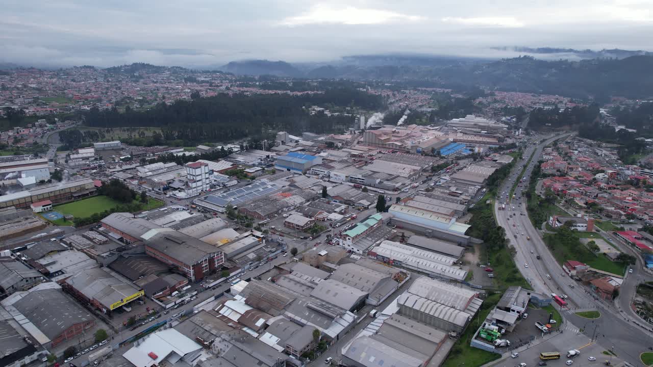 4K 60fps drone orbit over Cuenca’s industrial park in the morning. Shows factories, warehouses, and highway access with soft natural light and clear city infrastructure layout.