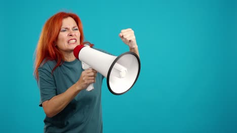 angry red-haired woman shouting into a megaphone