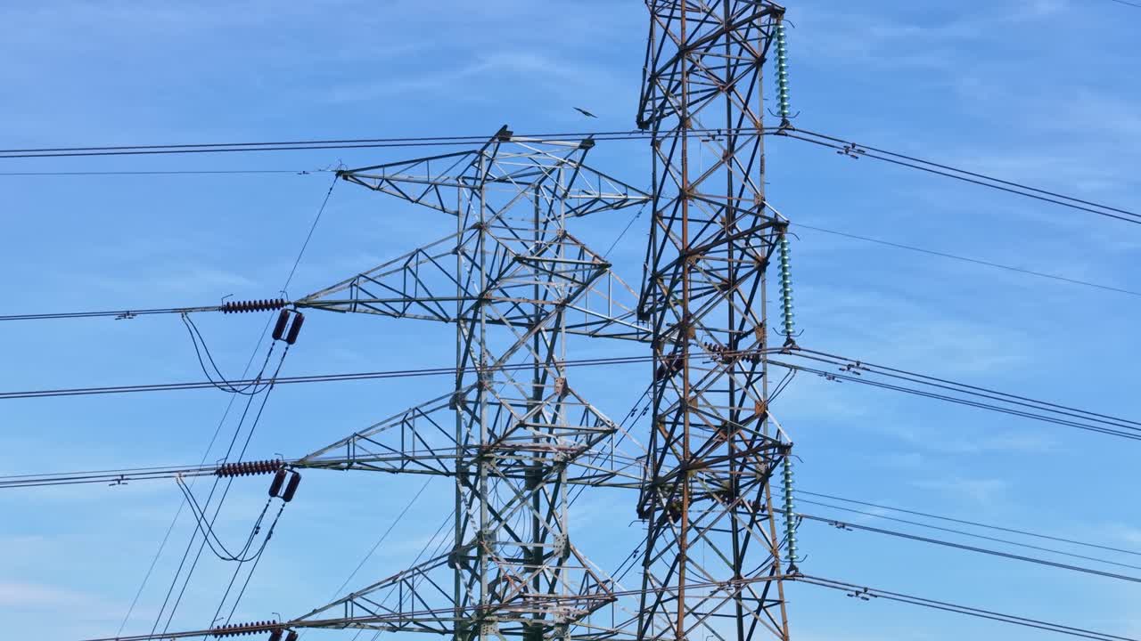 Energy transmission towers with cables, showcasing electricity distribution and modern engineering