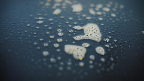 foaming hygiene spray is sprayed onto a black reflective surface for disinfection