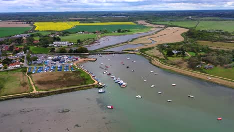 Drone-panning-over-the-sea,-looking-at-a-dock-with-boats-out