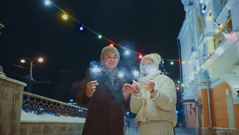 couple celebrating new year's eve with sparkler