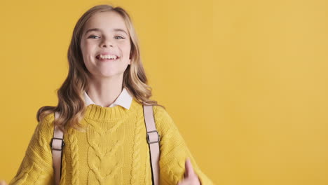 Happy-teenage-Caucasian-girl-with-thumbs-up-wearing-backpack.