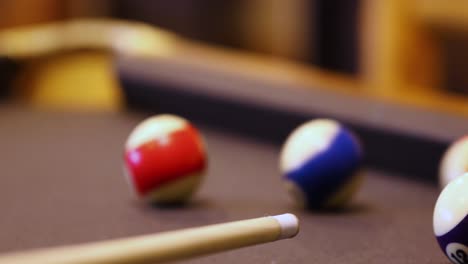 playing billiards - hitting balls with cue stick - close up