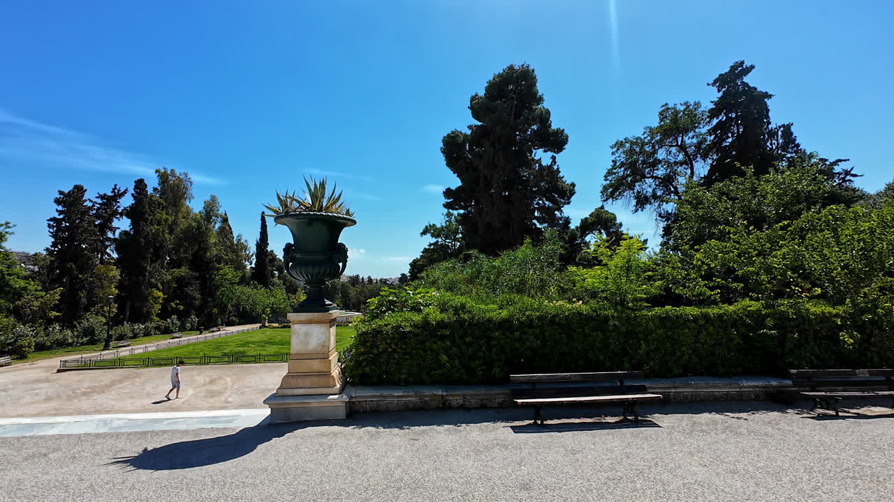 Lush garden in Athens, Greece, with vibrant greenery and a clear blue sky