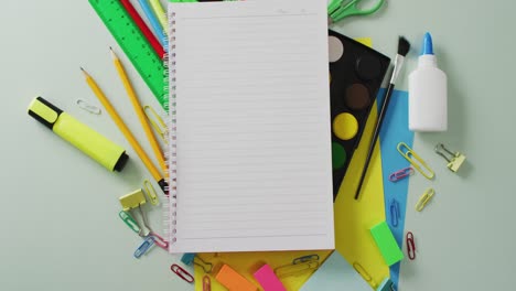 video of notebook with copy space and school equipment on grey background