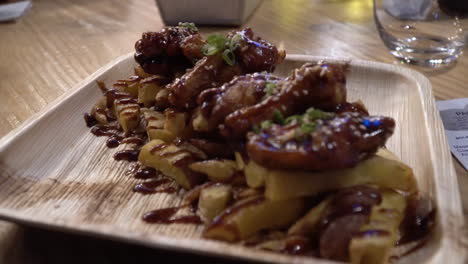 chicken wings and fries covered with bbq sauce