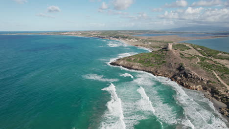 Torre-di-San-Giovanni-di-Sinis,-Sardinia:-drone-view-in-a-circle-over-the-famous-tower-and-seeing-a-spectacular-landscape