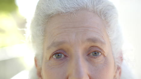 Portrait-of-happy-senior-biracial-woman-at-balcony-at-home,-slow-motion,-copy-space