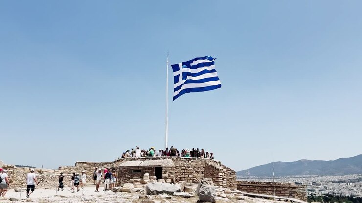Greek Flag Waving at the Acropolis Viewpoint, Athens, Greece