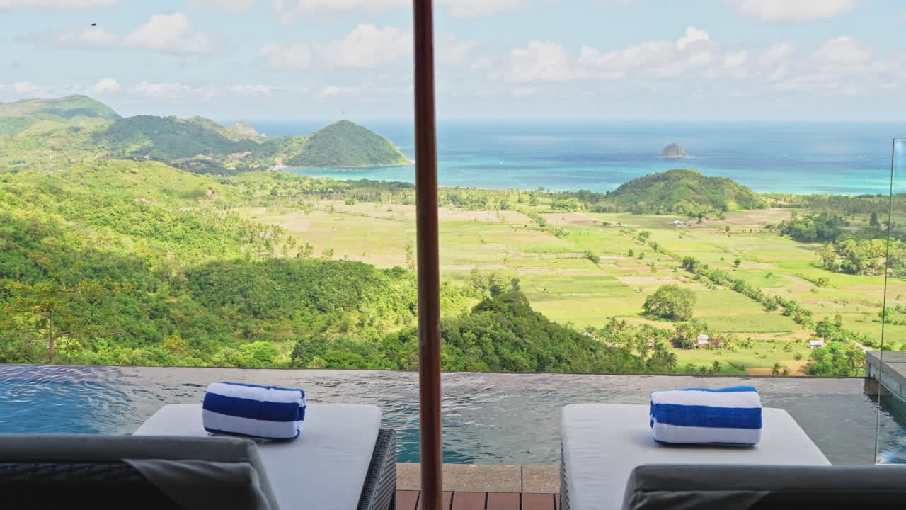 Cinematic slider reveal of infinity pool overlooking the mountains of Southern Lombok in Indonesia