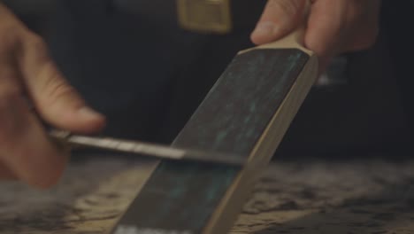 process of sharpening knife in the kitchen - close up