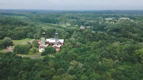 disused industrial colliery amid lush green reforested landscape aerial