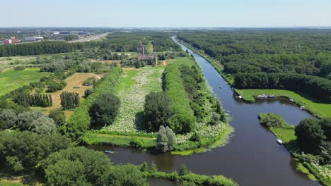 Aerial-drone-shot-above-a-nature-park,-water-canal,-abandoned-kastel-of-Almere-city,-province-Flevoland,-Netherlands