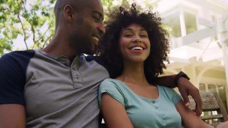 happy mixed race couple enjoying in the garden during a sunny day