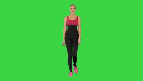 happy healthy sporty girl walking on a green screen, chroma key