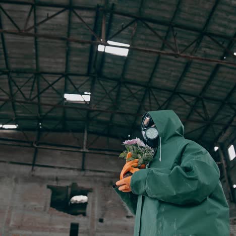 man in ruined industrial building. man wearing gas masks after nuclear disaster