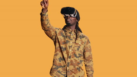 Cool-guy-using-virtual-reality-glasses-in-studio