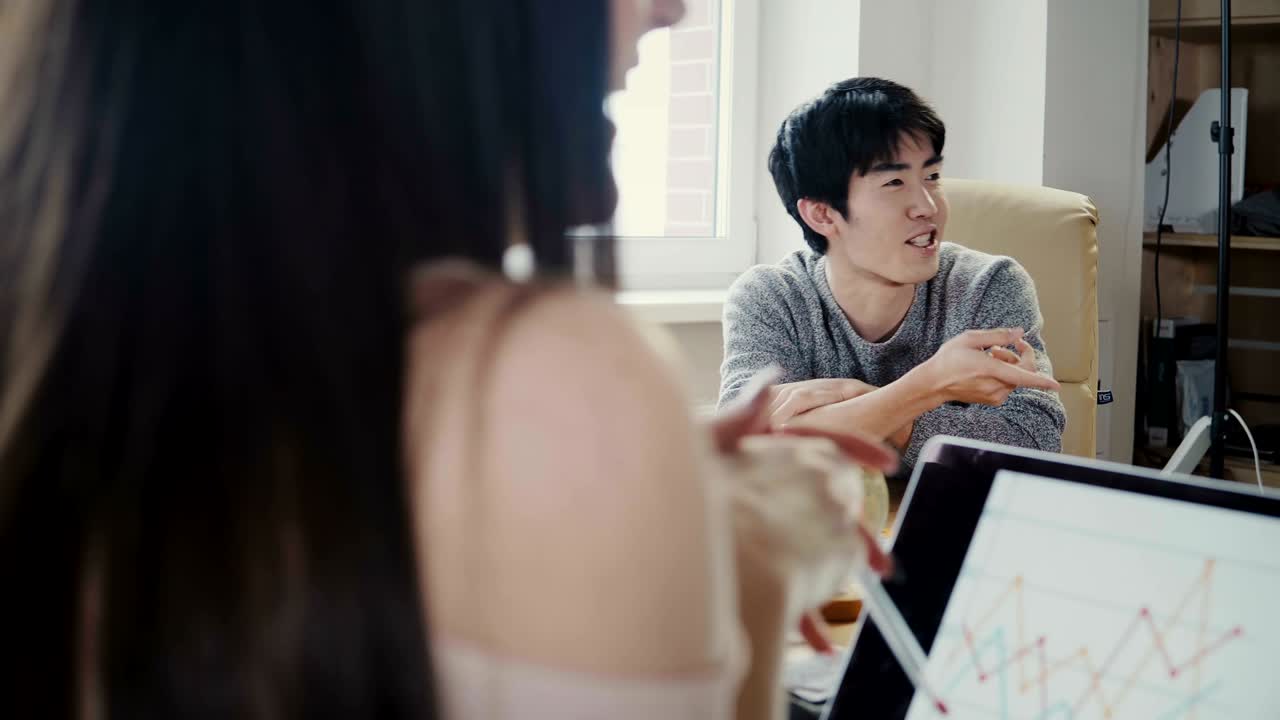 아시아의 젊은 기업가가 금융 비즈니스 교육 세미나에서 연설합니다. 다민족 팀은 암호화폐에 대해 논의합니다.