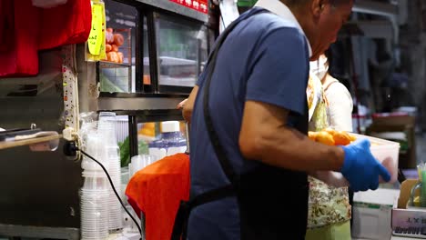 two people making fresh juice at a stall