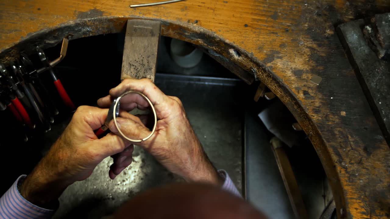 Goldsmith manufacturing jewellery in workshop 4k